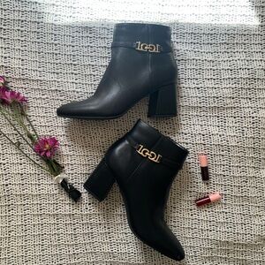 Black leather ankle boots with gold logo detail